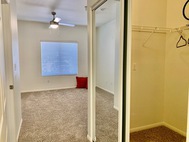 Ritiro Apartments carpeted bedroom with closet