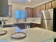 Ritiro Apartments Las Vegas brown cabinet kitchen quartz countertop