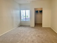 Ritiro Apartments Las Vegas carpeted bedroom with window and closet